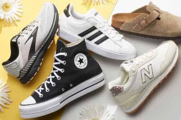 an array of sneakers and casual shoes displayed against a backgound of white and yellow accented with daisies, Adidas, Converse, Birkenstocks, Brooks, New Balance